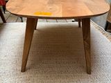 a wooden table with a plant on top of it