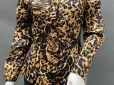 a mannequin wearing a leopard print top and black pants