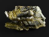 un gros plan d'un fragment de minéral sur une surface noire