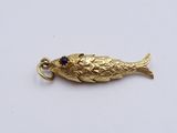 an image of a gold fish charm on a white surface