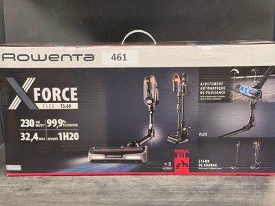 the box is open on the floor with the vacuum in it