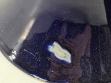 someone is taking a picture of themselves in the reflection of a blue vase