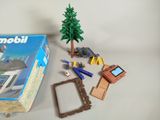 a box of playmobil with a picture frame, a tree, a picture frame, a picture frame, and a picture frame