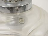a glass jar with a metal lid on a table