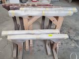 several rolls of wood sit on top of a table in a garage