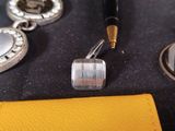 a pen that is laying on a piece of leather
