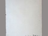 an old piece of paper with writing on it sitting on top of a table