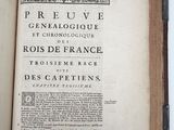 an open book on a white table with a black border