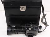 a camera and a case sitting on a white surface