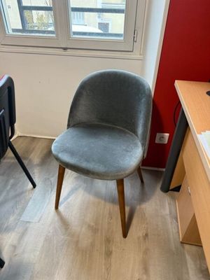 a chair in the corner of a room with a computer on it