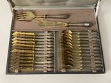 silverware in a case with knives and spoons on a table