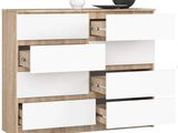 a close up of a white and wood dresser with drawers