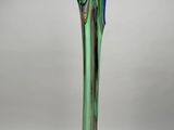 a green glass vase with a blue and brown swirl on it