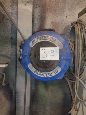 a blue fire hydrant with a sign on the side of it