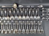 a lot of silver spoons and spoon spoons on the table