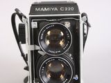 a black and white photo of a camera on a white surface
