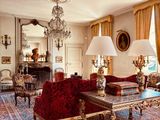 a living room with a lot of furniture and a chandelier