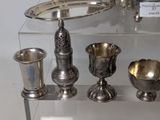 a glass display case with silver objects on it