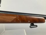 a close up of a rifle on a stand with a white background