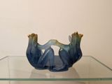 a glass table with a glass bowl on top of it