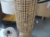 a wicker lamp that is sitting on the floor