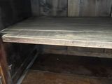a wooden cabinet with a shelf on top of it