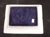 a small white plate with a purple cloth inside of it