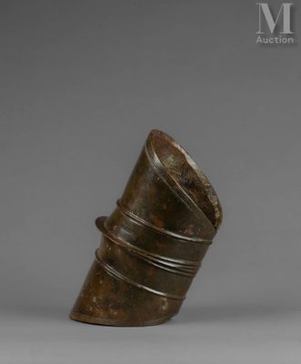 an old bronze vase sitting on top of a table