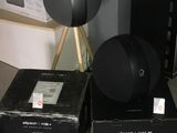two black speakers sitting on top of boxes on the floor