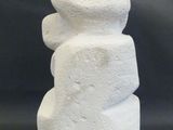 a white stone sculpture that looks like a stack of rocks