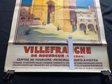 a poster on the wall of a building advertising a tour