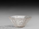 an image of a glass bowl on a table with a shadow on the ground