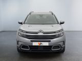 the front of a silver citrole parked in a white room