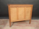 an image of a small wooden cabinet on wheels