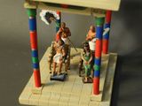 a small toy figurine of a man and a woman on a bench
