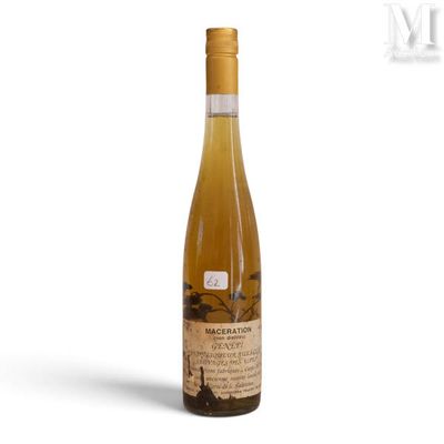 the bottle of wine is sitting on a white surface
