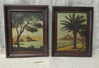 two framed paintings of a beach scene with palm trees and buildings