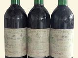 three bottles of wine are lined up in a row on a table