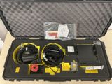 a black case with a yellow and black device inside of it