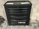 an image of a black tool cabinet sitting on top of a cement floor