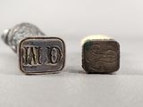 two small silver metal objects sitting next to each other on top of a table