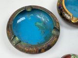 three different colored bowls on a table with one bowl on the other