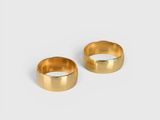a pair of gold rings on a white background