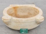 a stone bowl that is sitting on the ground