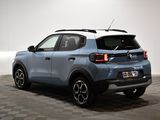the rear end of a blue suv parked in a room