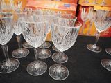 six wine glasses sitting on a table with a box of wine glasses in the background