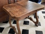 a wooden table that is sitting on a checkered floor