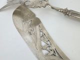 a silver spoon and a silver spoon on a white table