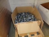 a cardboard box full of nuts and bolts on a pallet