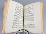 a magnifying glass sitting on top of an open book